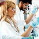 Scientists in a lab researching advanced regenerative medicine therapies to optimize cellular health over traditional symptom management.