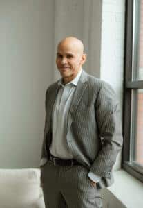 Portrait of Dr. Stefano Sinicropi in a gray suit, the spine surgeon named to the Genesis Regenerative Clinical Advisory Board.